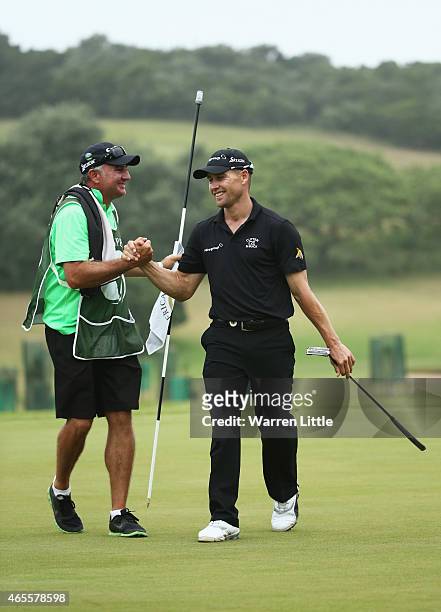 Trevor Fisher Jnr of South Africa celebrates victory with his caddie on the 18th green during the final round of the Africa Open at East London Golf...