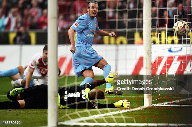Alexander Meier of Frankfurt scores his team's first goal against goalkeeper Timo Horn of Koeln during the Bundesliga match between 1. FC Koeln and...