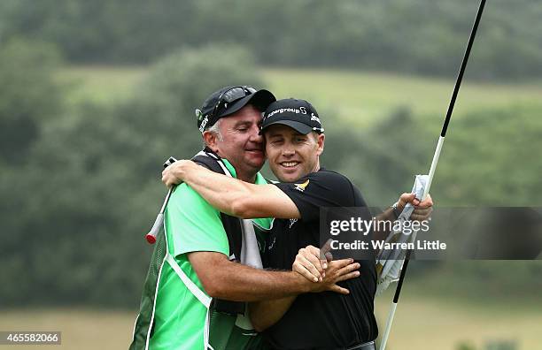 Trevor Fisher Jnr of South Africa celebrates with his caddie after winning the Africa Open at East London Golf Club on March 8, 2015 in East London,...