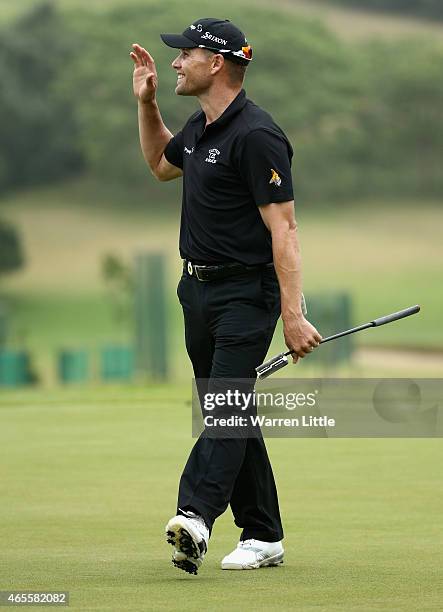 Trevor Fisher Jnr of South Africa acknowledges the crowd on the 18th green after winning the Africa Open at East London Golf Club on March 8, 2015 in...