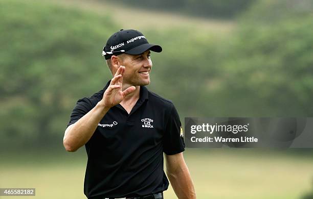 Trevor Fisher Jnr of South Africa acknowledges the crowd on the 18th green after winning the Africa Open at East London Golf Club on March 8, 2015 in...