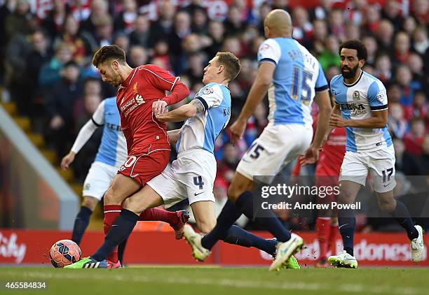 Adam Lallana of Liveprool competes with Matthew Kilgallon of Blackburn Rovers during the FA Cup Quarter Final match between Liverpool and Blackburn...