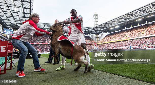 Anthony Ujah of Koeln celebrates his team's fourth goal with mascot Hennes during the Bundesliga match between 1. FC Koeln and Eintracht Frankfurt at...