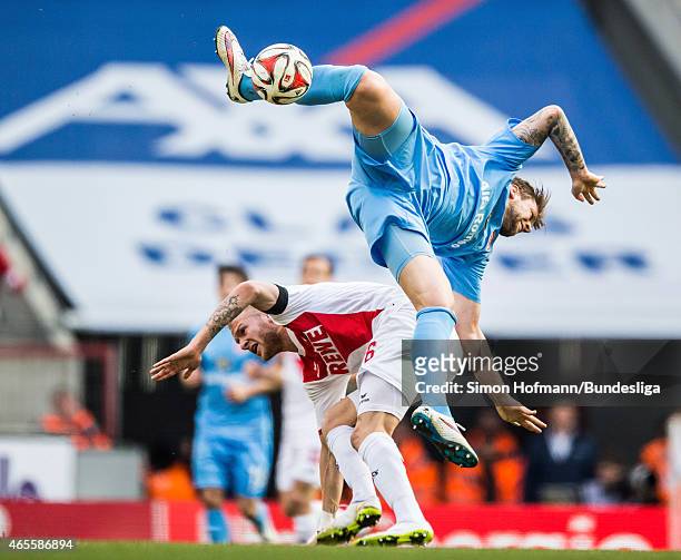 Marco Russ of Frankfurt jumps for a header with Kevin Vogt of Koeln during the Bundesliga match between 1. FC Koeln and Eintracht Frankfurt at...