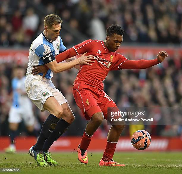 Daniel Sturridge of Liverpool competes with Matthew Kilgallon of Blackburn Rovers during the FA Cup Quarter Final match between Liverpool and...