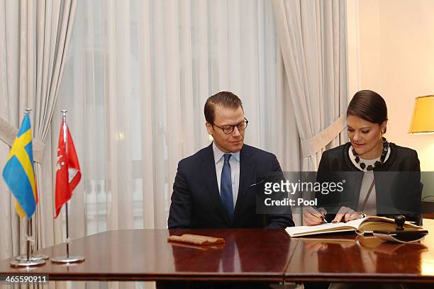 Crown Princess Victoria of Sweden and Prince Daniel of Sweden sign the guest book as they attend the "Modern Green Cities" conference at the Chamber...