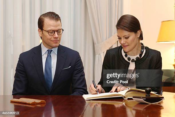 Crown Princess Victoria of Sweden and Prince Daniel of Sweden sign the guest book as they attend the "Modern Green Cities" conference at the Chamber...