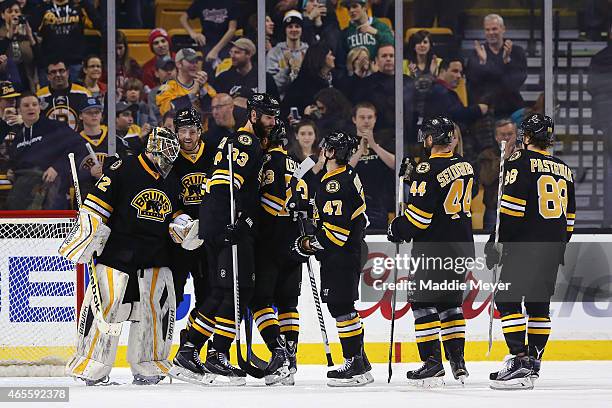 Niklas Svedberg of the Boston Bruins is congratulated by his teammates after they won their game against the Detroit Red Wings at TD Garden on March...