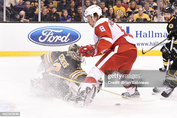 Niklas Svedberg of the Boston Bruins tries to stop the puck against Justin Abdelkader of the Detroit Red Wings at the TD Garden on March 8, 2015 in...