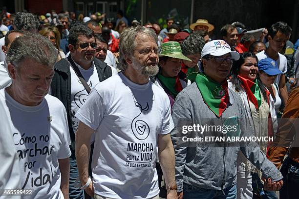 Colombia's President Juan Manuel Santos and Bogota's former Mayor Antanas Mockus walk during the "March For Life" in Bogota, Colombia, on March 8,...