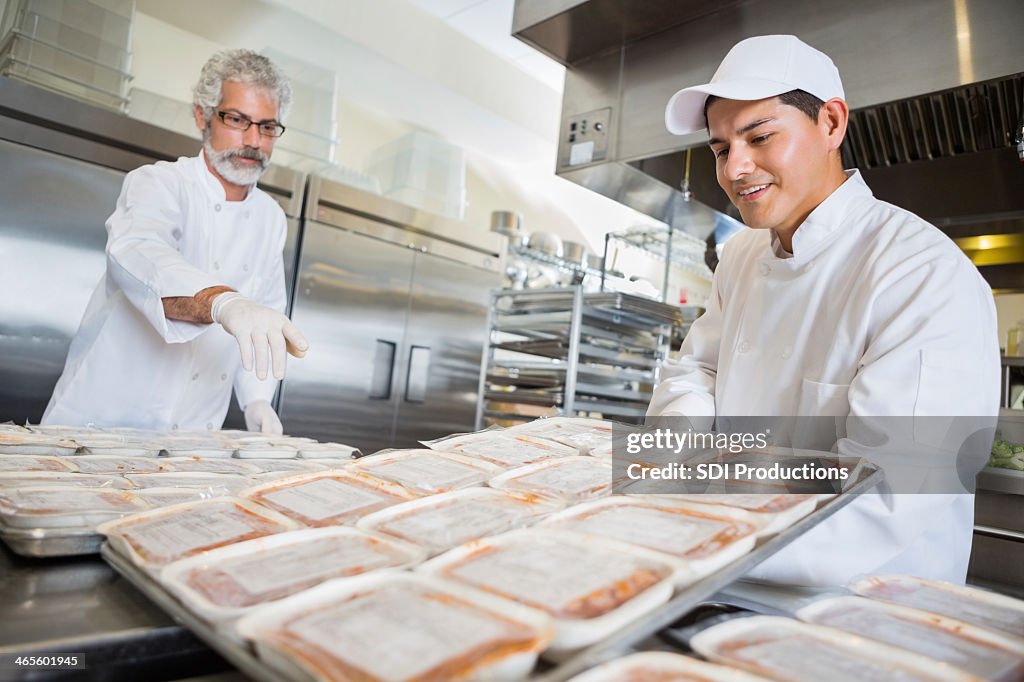 Volunteer chefs preparing frozen meals for food bank