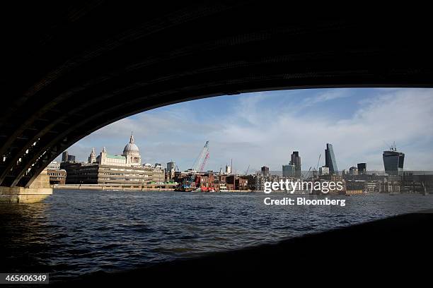 St Paul's cathedral, left, and skyscrapers stand on the horizon in the City of London from the south bank of the River Thames in London, U.K., on...