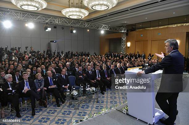 French President Francois Hollande listens as Turkish President Abdullah Gul makes a speech as at the Turkish French Business Forum in Istanbul,...