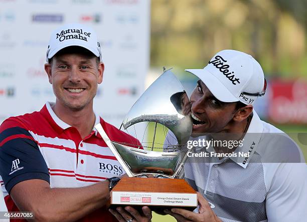 Henrik Stenson of Sweden and Rafa Cabrera-Bello of Spain with the trophy that they shared after finishing on six under par during the Champions...