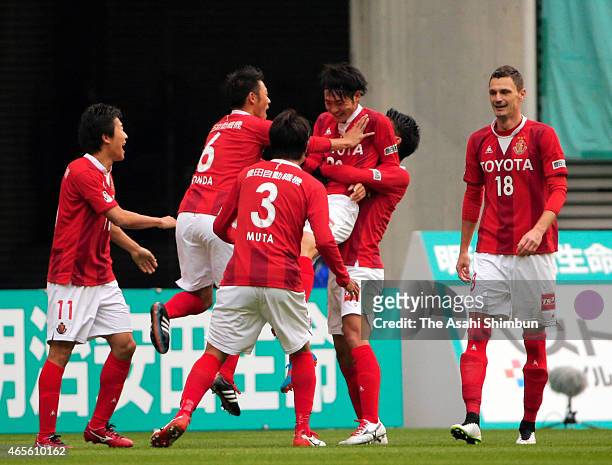 Tomoya Koyamatsu of Nagoya Grampus celebrates scoring his team's first goal with his team mates during the J.League match between Nagoya Grampus and...