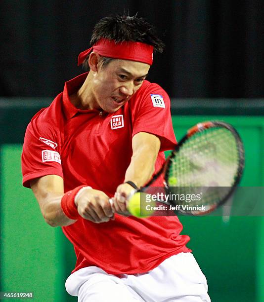 Kei Nishikori of Japan returns a shot during his Davis Cup match against Milos Raonic of Canada March 8, 2015 in Vancouver, British Columbia, Canada....