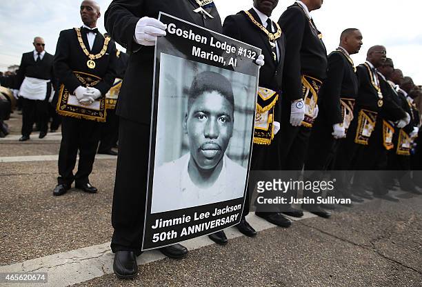 Marcher holds a poster of Jimmie Lee Jackson, a civil rights activist who was beaten and shot by Alabama State troopers in 1965, during the 50th...