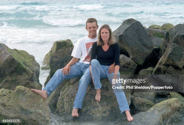 Andrew Coltart of Great Britain sitting on rocks beside the sea with his girlfriend Emma during the Dubai Desert Classic Golf Tournament held at the...