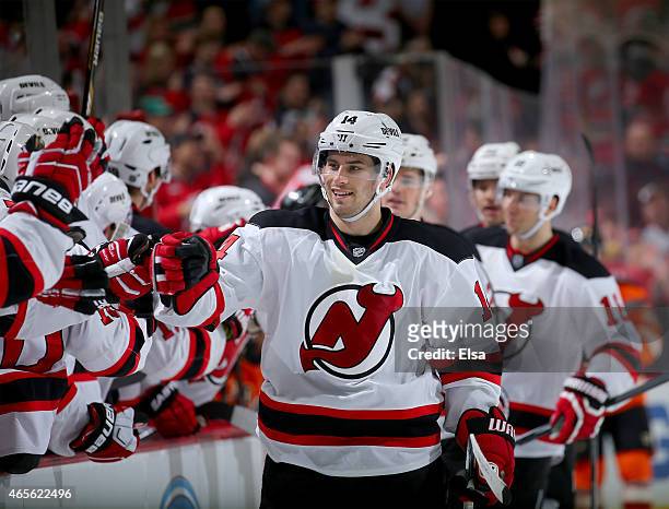 Adam Henrique of the New Jersey Devils celebrates his goal with teammates on the bench in the third period against the Philadelphia Flyers on March...