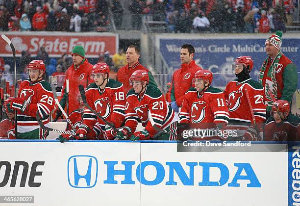 Anton Volchenkov, Steve Bernier, Ryan Carter, Stephen Gionta and Patrik Elias of the New Jersey Devils watch game action from the bench area during...