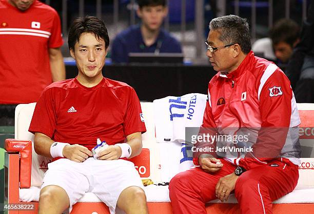 Japanese coach Minoru Ueda talks to Go Soeda of Japan during their Davis Cup match against Vasek Pospisil of Canada March 8, 2015 in Vancouver,...