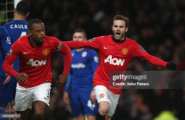 Juan Mata of Manchester United celebrates Robin van Persie scoring their first goal during the Barclays Premier League match between Manchester...