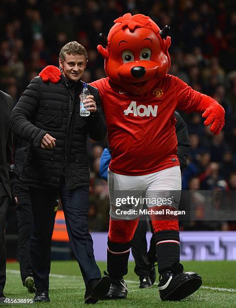 Cardiff City Manager Ole Gunnar Solskjaer is greeted by mascot Fred the Red prior to the Barclays Premier League match between Manchester United and...