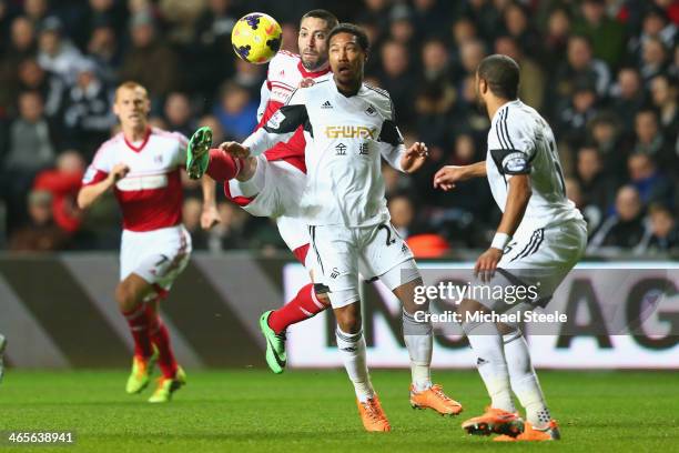 Jonathan de Guzman of Swansea City challenges for the ball with Clint Dempsy of Fulham during the Barclays Premier League match between Swansea City...