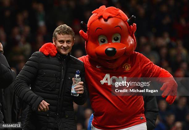 Cardiff City Manager Ole Gunnar Solskjaer is greeted by mascot Fred the Red prior to the Barclays Premier League match between Manchester United and...