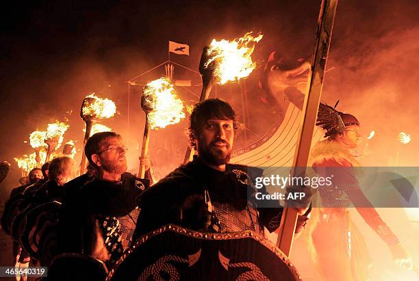 Participants dressed as Vikings carry burning brands as they take part in the annual Up Helly Aa festival in Lerwick, Shetland Islands, on January...