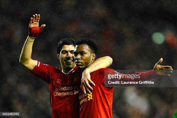 Daniel Sturridge of Liverpool is congratulated by teammate Luis Suarez after scoring his team's third goal during the Barclays Premier League match...