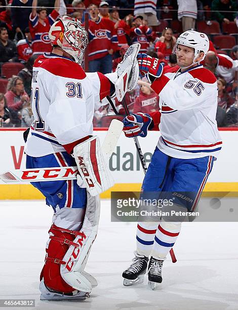 Goaltender Carey Price of the Montreal Canadiens is congratulated by Sergei Gonchar after defeating the Arizona Coyotes 2-0 in the NHL game at Gila...
