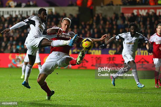 Nathan Dyer of Swansea City shoots despite the attentions of Brede Hangeland of Fulham during the Barclays Premier League match between Swansea City...