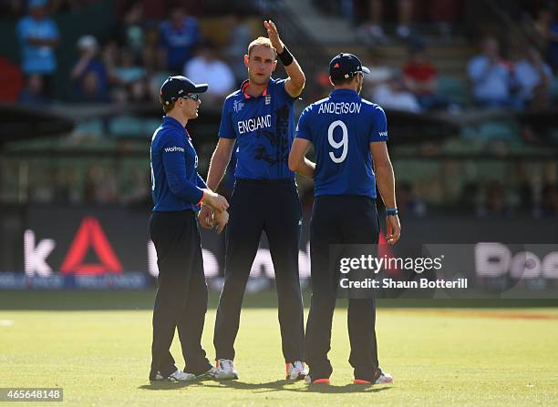 Stuart Broad of England talks with captain Eoin Morgan and James Anderson during the 2015 ICC Cricket World Cup match between England and Bangladesh...