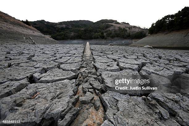 Pipe emerges from dried and cracked earth that used to be the bottom of the Almaden Reservoir on January 28, 2014 in San Jose, California. Now in its...