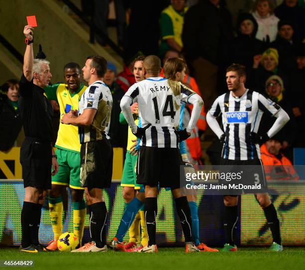 Referee Chris Foy shows Loic Remy of Newcastle United a red card during the Barclays Premier League match between Norwich City and Newcastle United...