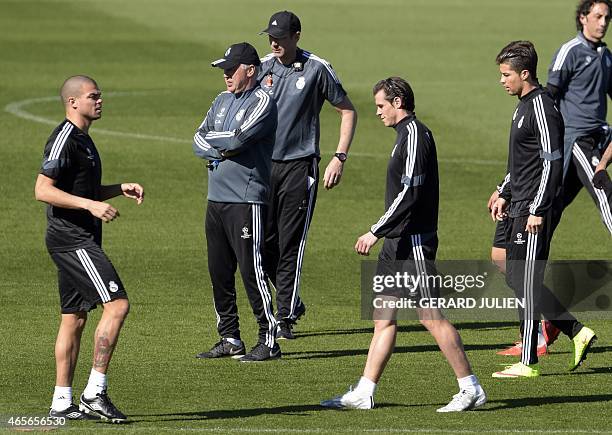 Real Madrid's Portuguese defender Pepe, Real Madrid's Welsh forward Gareth Bale and Real Madrid's Portuguese forward Cristiano Ronaldo walk in front...