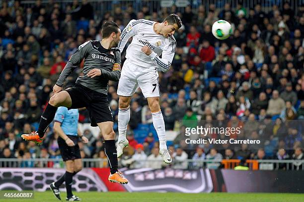 Cristiano Ronaldo of Real Madrid heads the ball beside Sergio Garcia of Espanyol during the Copa del Rey Quarter Final, second leg match between Real...
