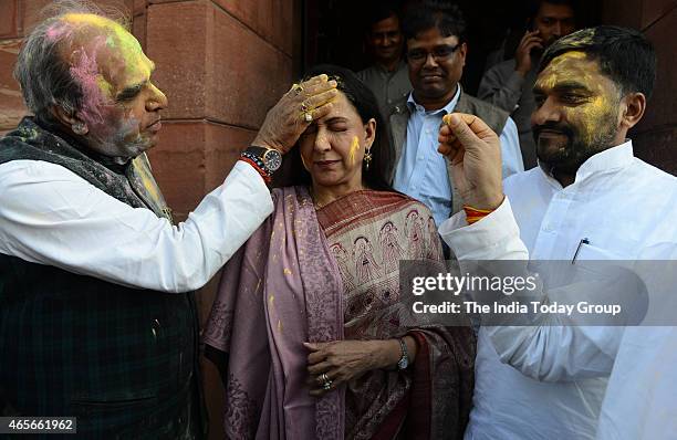 MPs Jagadambika Pal and Hema Malini celebrating Holi at Parliament House in New Delhi.