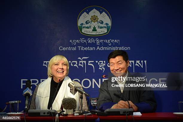 Lobsang Sangay , leader of the exiled Central Tibetan Administration, and Claudia Roth, vice president of the German parliament, share a light moment...