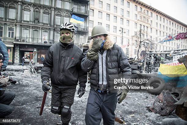 Protesters walk on Grushevskogo Street on January 28, 2014 in Kiev, Ukraine. President Viktor Yanukovych has accepted the resignation of Prime...