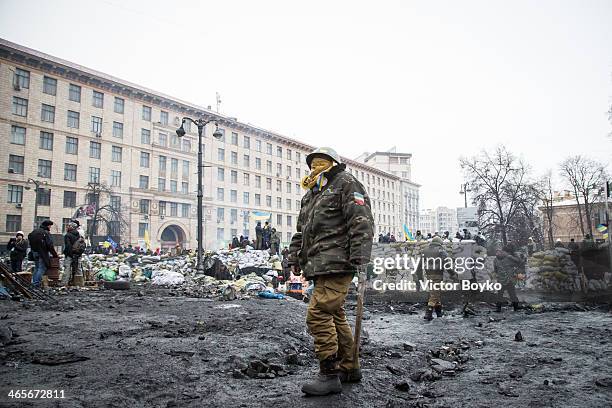 Protester stands watch at the barricade on Grushevskogo Street on January 28, 2014 in Kiev, Ukraine. President Viktor Yanukovych has accepted the...