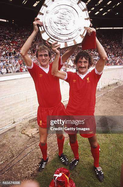 Liverpool players Phil Thompson and Terry McDermott hold the FA Charity Shield aloft after a 1-0 win over West Ham at Wembley Stadium on August 9,...