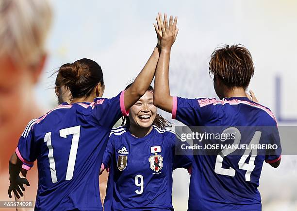 Japan's midfielder Nahomi Kawasumi celebrates her goal with mates forward Yuki Ogimi and forward Yuika Sugasawa during the Algarve Cup football match...