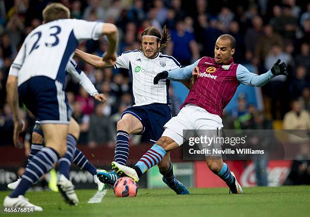 Gabriel Agbonlahor of Aston Villa is challenged by Jonas Olsson of West Bromwich Albion during the FA Cup FA Cup Quarter Final match between Aston...