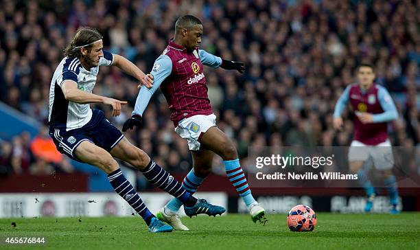 Chales N'Zogbia of Aston Villa is challenged by Jonas Olsson of West Bromwich Albion during the FA Cup FA Cup Quarter Final match between Aston Villa...