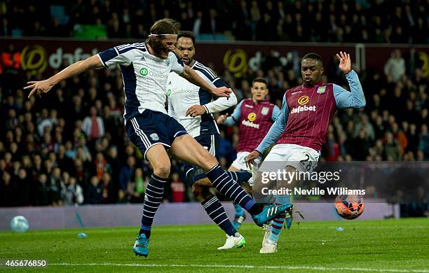 Chales N'Zogbia of Aston Villa is challenged by Jonas Olsson of West Bromwich Albion during the FA Cup FA Cup Quarter Final match between Aston Villa...