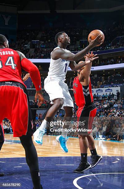 Lance Stephenson of the Charlotte Hornets shoots against Chuck Hayes of the Toronto Raptors on March 6, 2015 at Time Warner Cable Arena in Charlotte,...
