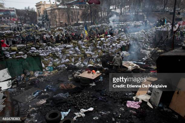 Protesters stand watch behind a barricade on January 28, 2014 in Kiev, Ukraine. While Ukrainian parliament holds an emergency session, standoff...