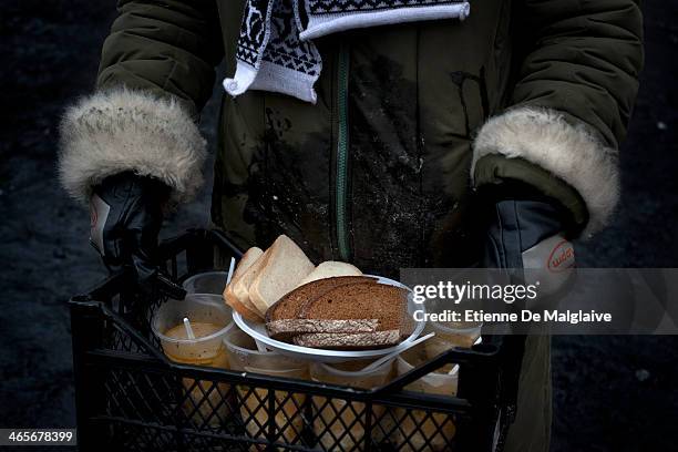 Volunteer delivers soup and bread to the protesters maning the barricades on January 28, 2014 in Kiev, Ukraine. While Ukrainian parliament holds an...